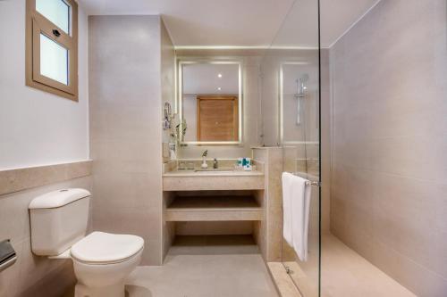 a bathroom with a toilet and a sink at JAZ Little Venice Golf Resort in Ain Sokhna