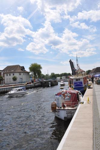 a group of boats are docked in a river at Apartment in der Altstadt in Ueckermünde