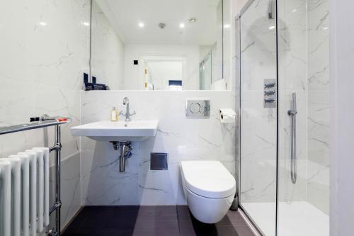a bathroom with a toilet and a sink and a shower at Lews Castle in Stornoway