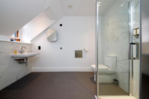 a bathroom with a shower and a toilet and a sink at Lews Castle in Stornoway