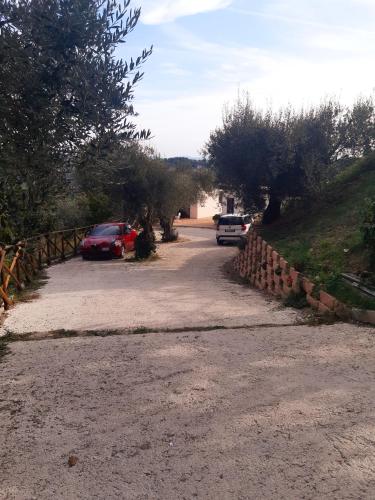 a road with cars parked on the side of a hill at la dimora degli angeli in Perugia