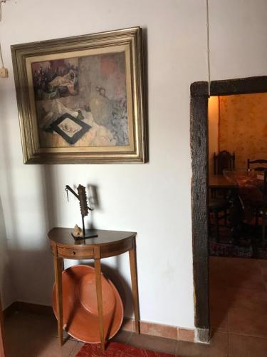 a table with a microscope on it next to a painting at Casa da Praça - Mourão in Mourão