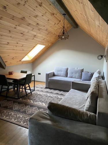 a living room with a couch and a table at Girske Povitria 2 in Yaremche