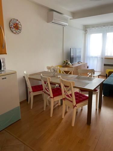 a kitchen and dining room with a table and chairs at Apartment Dony in Donovaly