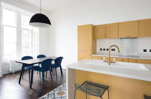 a kitchen with a table and chairs and a sink at Lews Castle in Stornoway