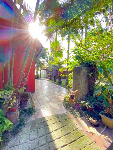 a sidewalk with a bunch of plants and trees at Pousada Tia Maria in Ilha do Mel