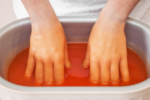 two legs in a container filled with orange liquid at Sanatorija ,,Tulpės" in Birštonas
