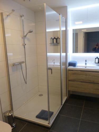 a bathroom with a shower and a sink at Hotel Abdijhof Thorn in Thorn