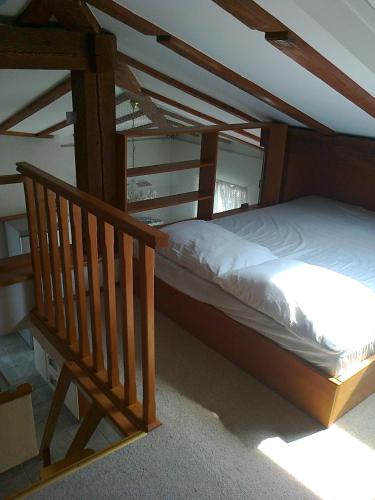 a wooden bunk bed in a room with a staircase at Apartments Zlatko Delic in Ika
