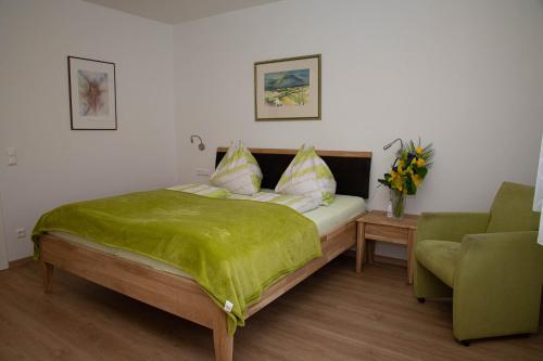 Un dormitorio con una cama con una manta verde. en Villa Mayr en Villach