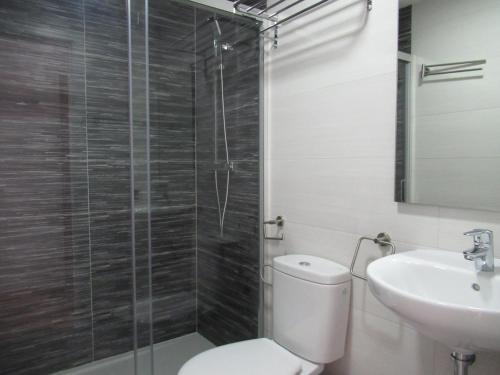 a bathroom with a shower and a toilet and a sink at NÁUTICO Suites, by Comfortable Luxury - Adults Only in Corralejo
