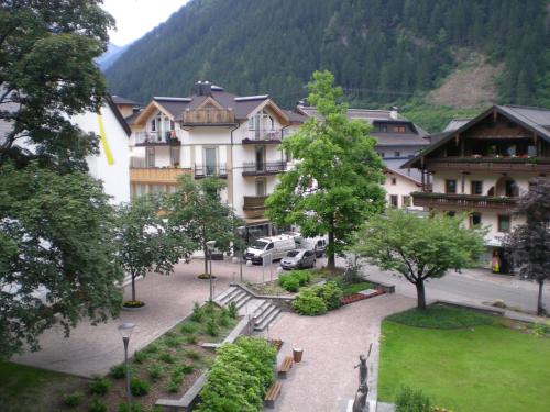 a view of a courtyard with a building and trees at Alpenhotel Kramerwirt in Mayrhofen