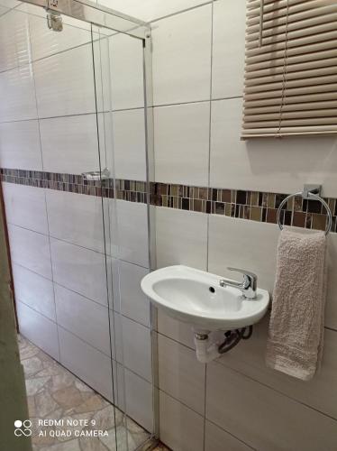 a bathroom with a sink and a glass shower at Atholl Heights Homee in Westville