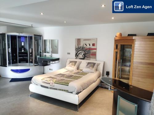 a bedroom with a bed and a dresser at Loft Zen SPA Balneo Parking Gratuit Sauna Hammam Billard in Agen