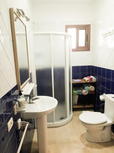 a bathroom with a shower and a toilet and a sink at Bimbache Home in Frontera
