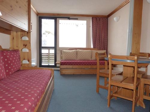 une chambre avec un lit, un bureau et une table dans l'établissement travelski home classic - Vue Pistes, à Aime La Plagne