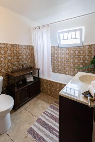a bathroom with a tub and a toilet and a sink at Quinta Pereirinha Farm - A Private 3 Bedroom Vacation Home, Close to Hiking w Ocean Views - Pico Island, Azores in São Roque do Pico