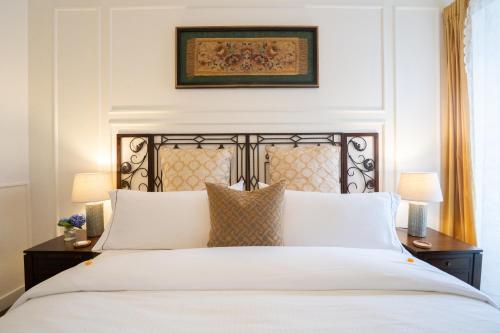 a bedroom with a white bed and two lamps at Quinta Pereirinha Farm - A Private 3 Bedroom Vacation Home, Close to Hiking w Ocean Views - Pico Island, Azores in São Roque do Pico
