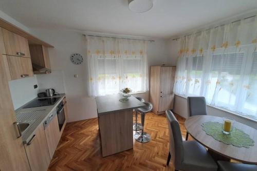 a kitchen with a table and a small table and chairs at Apartman Robert *** in Duga Resa