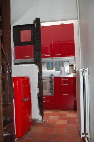 a kitchen with red cabinets and a red refrigerator at Zuiderzin in Antwerp