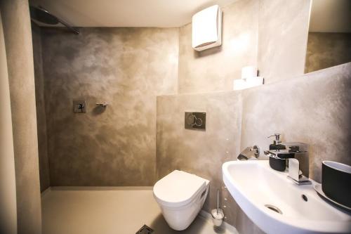 a bathroom with a white toilet and a sink at Klášterní apartmány in Český Krumlov