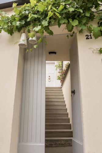 a staircase leading to a white building with a door at La Foresteria - Casa Vacanze Norcia in Norcia