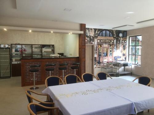 a room with a table and chairs and a bar at Penzion Florian in Moldava