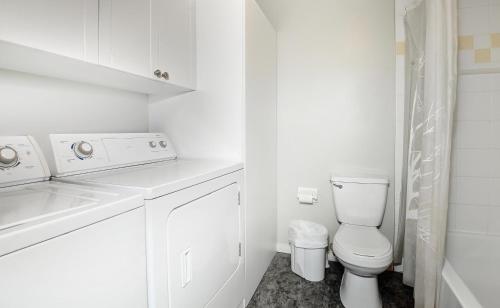 a white bathroom with a sink and a toilet at Chalets Alpins- 19 Chemin Alpin in Stoneham