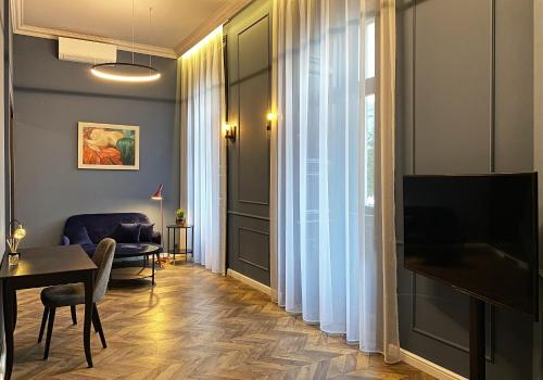 布達佩斯的住宿－Hotel Rumor，客厅配有桌子和电视