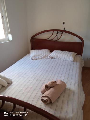 a bed with a towel laying on top of it at Casa Avô T1 in Avô