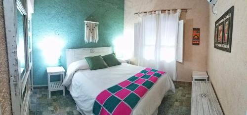 a bedroom with a large bed in a room at Cabaña Chañares de Banda Florida - Ama in Villa Unión