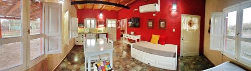 two pictures of a bedroom with red walls and a bed at Cabaña Chañares de Banda Florida - Ama in Villa Unión