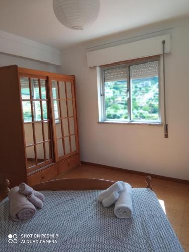 a bedroom with two towels sitting on a bed at Casa Avô in Avô
