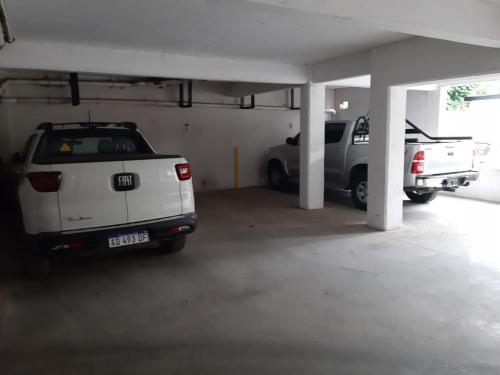a parking garage with two cars parked in it at Departamento Centrico en Bariloche in San Carlos de Bariloche