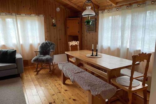 Charming Mountain Cabin في أوبدال: غرفة طعام مع طاولة وكراسي خشبية