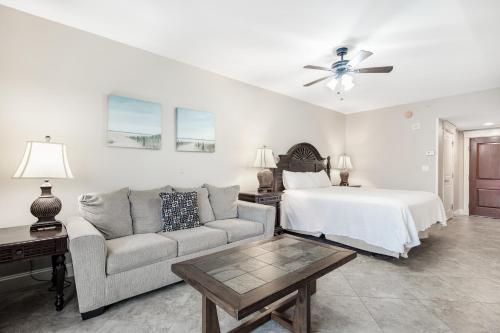 a living room with a bed and a couch at The Grand 2311 in Destin