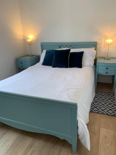 a bedroom with a large bed with two night stands at Doolin View Apartment in Doolin
