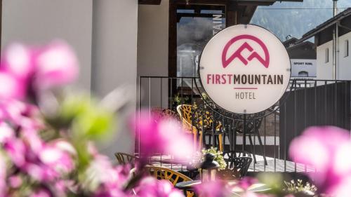 a first moon train hotel sign in front of pink flowers at first mountain Hotel Ötztal in Längenfeld