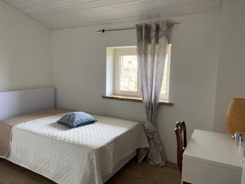 a bedroom with a bed and a window at Cammino Nel Verde in Fornovo di Taro