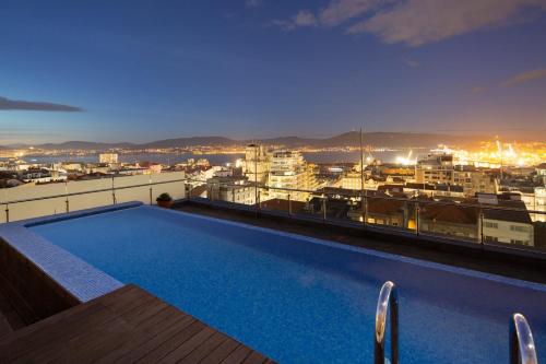 a swimming pool on the roof of a building at Silken Axis Vigo in Vigo
