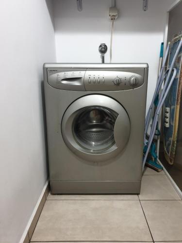 a washing machine in a corner of a room at Apartment Tryavna in Tryavna