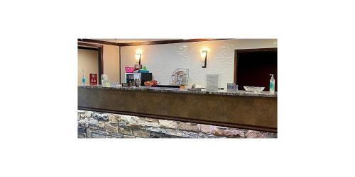 a bar in a hotel room with a counter at Wichita West Inn and Suites in Wichita