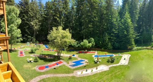 an aerial view of a park with a playground at Hotel Waldheim in Sarnonico