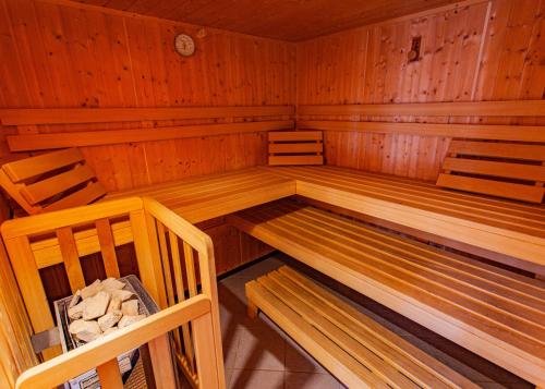 an empty sauna with two wooden chairs in it at Gästehaus Hartweger in Haus im Ennstal