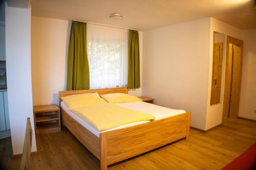a bedroom with a bed in a room with a window at Gasthof-Pension Riedl in Vöcklamarkt
