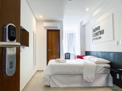 a hotel room with two beds and a tv at HOTEL NOVO CENTRO in Petrolina