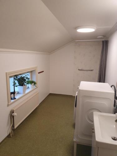 a bathroom with a toilet and a window and a sink at Gramersgården in Söderala