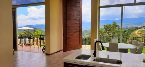 a kitchen with a view of a balcony at Mountain View Anapoima in Anapoima