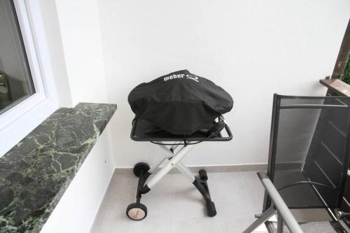 a black chair sitting next to a wall at Apartment Panoramablick in Böbrach