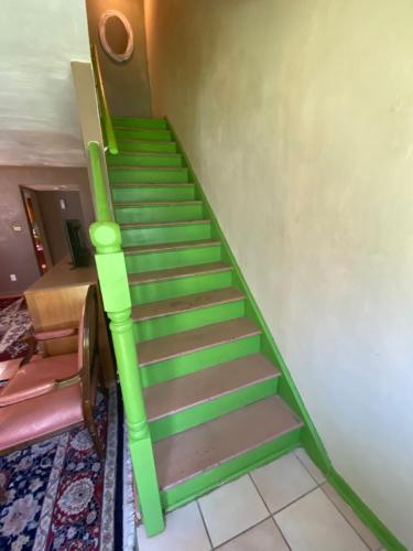 a staircase with green and brown steps in a room at Va Beach Zen town house in Virginia Beach